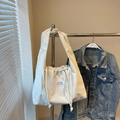 White corduroy tote bag with drawstring closure and textured vertical stripes - Off White