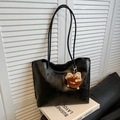 Minimalist black faux leather tote bag with a brown plush monster charm on its handle - With Charm / Black