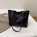 Large black tote bag with wrinkled leather texture and vertical stitching details - Black