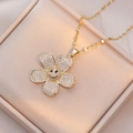 Gold flower smiley face necklace with sparkling white zircons on a pink satin background - Smile Flower Style (X1009) / Gold