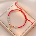 Handmade red woven bracelet featuring jade beads and a gold hollow 'Fu' charm pendant - Hetian Jade Fu Charm (TS0285)