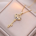 Golden heart key pendant necklace with blue sapphire and zircon stones on silk - Blue
