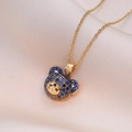 Collana con ciondolo a orso dorato con zirconi blu e neri su seta champagne - Collana Orsetto Blu Notte