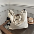 Detail of beige drawstring tote bag with a ruffled scrunchie strap and cute sheep charm - Khaki (With Charm)
