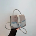 Light gray structured handbag with crocodile texture trim and gold buckle detail - Gray