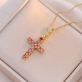 Elegant gold cross pendant necklace with orange zircon stones in a luxury gift box - Orange