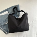 Black minimalist hobo bag with unique scrunchie shoulder strap and drawstring detail - Black