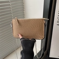 Close-up of khaki faux crocodile texture bag with elegant silver chain strap detail - Khaki