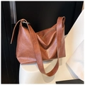 Dettaglio della borsa tote vintage marrone con trama in pelle e tracolla larga - Marrone