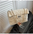 White quilted faux leather crossbody bag with silver chain strap and metal lock detail - White