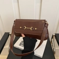 Dark brown faux leather underarm bag with gold horsebit buckle and glossy finish - Brown