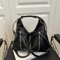 Fashionable black hobo shoulder bag with bow accents and silver zipper details - Black