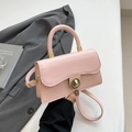 Pink minimalist crossbody bag with gold round twist lock and smooth leather texture - Pink