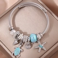 Bracciale argento con ciondoli a stella marina, tartaruga e perla di vetro blu su seta - Azzurro