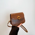 Retro dark brown crossbody bag with oily leather texture and golden horseshoe buckle - Brown