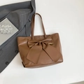Deep brown faux leather tote bag with a large decorative bow and spacious interior - Brown