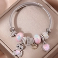 Detail of beaded wire bracelet with sparkling bear and pink heart pendants - Light Pink
