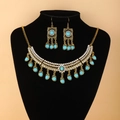 Detailed view of bohemian gold jewelry set with emerald stones and crystals on a model - Lake Blue Tassel Necklace Earring Set / Lake Blue