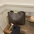 Retro bucket crossbody bag featuring brown monogram pattern and golden metal hardware - Brown