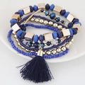 Bohemian multi-layer beaded bracelet set with blue beads and a tassel on ceramic plate - Blue
