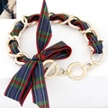 Detailed view of gold chain bracelet with plaid ribbon and large bow decoration - Blue and Yellow Plaid Style (2)