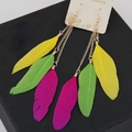 Detailed view of long gold chains with colorful feathers in yellow green and pink - Rose Red