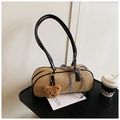 Detail der gewebten Strohtasche mit blau-karierter Schleife und braunem Bär-Anhänger - Schwarz mit Anhänger