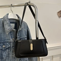 Minimalist black leather baguette bag with a sleek gold buckle and adjustable strap - Black