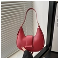 Detail view of the red half-moon handbag showing its matte texture and stitching - Red