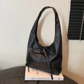 Minimalist black leather tote bag with bow detail and heart charm on books - Black