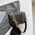 Chic black crossbody bag with textured flap and elegant gold chain strap detail - Black