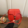 Elegant red leather saddle bag with gold hardware and stylish contrast stitching - Red
