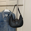 Vintage black leather crescent underarm bag with gold hardware on a casual hanger - Black