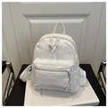 Macro shot of white corduroy backpack texture with zipper pocket on a white book - White