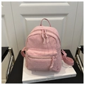 Detail of pink corduroy backpack featuring vertical texture and double zipper closures - Pink