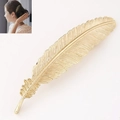 Close-up of golden metallic feather hair clip showing intricate textures and a model wearing it - Bright Gold