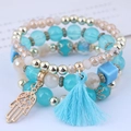 Multilayer bohemian beaded bracelet set in sky blue and gold with Fatima hand and tassel - Blue Hamsa Hand Style