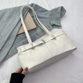 Weiße Baguette-Tasche aus Kunstleder mit Silberschnalle in lässiger Lifestyle-Atmosphäre - Gebrochenes Weiß