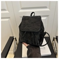 Detail of black backpack with unique crinkle texture and drawstring flap closure design - Black