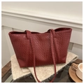 Close-up of deep red woven leather tote bag texture with elegant handle details - Red
