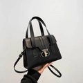 Classic black crossbody handbag for women with gold ring clasp and red edge detailing - Black