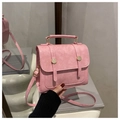 Detail of pink small square bag with pebble grain leather and golden metal hardware - Pink
