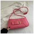 Detail of pink baguette bag with large gold square buckle and stylish knotted shoulder strap - Pink