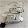 Detail of silver metallic baguette bag with bold gold buckle and knotted shoulder strap - Silver