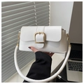 Detail of white leather baguette bag with a bold gold buckle and a wide circular strap - White