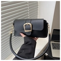 Detail of a black leather handbag featuring a large gold buckle and a cylindrical handle - Black