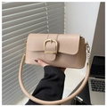 Detailed view of beige faux leather bag with oversized gold buckle and round handle - Khaki