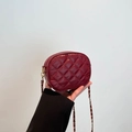 Elegant wine red quilted crossbody bag with gold chain strap and heart hardware details - Burgundy