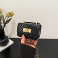 Mini black quilted leather crossbody bag with gold chain strap and turn-lock closure - Black