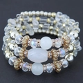 Detail of bohemian multilayer bracelet featuring crystals, cat eye beads and gold alloy spacers - White